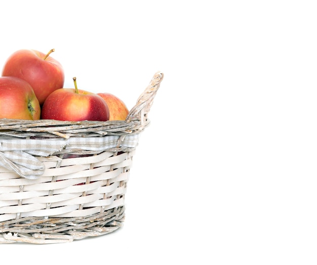 Fresh ripe apples in the basket isolated on white