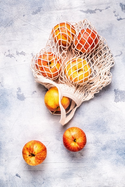 Fresh ripe apples in a mesh bag