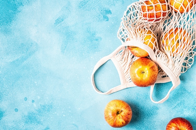 Fresh ripe apples in a mesh bag