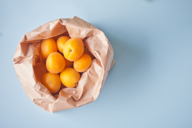 Fresh ripe apricots in a paper bag