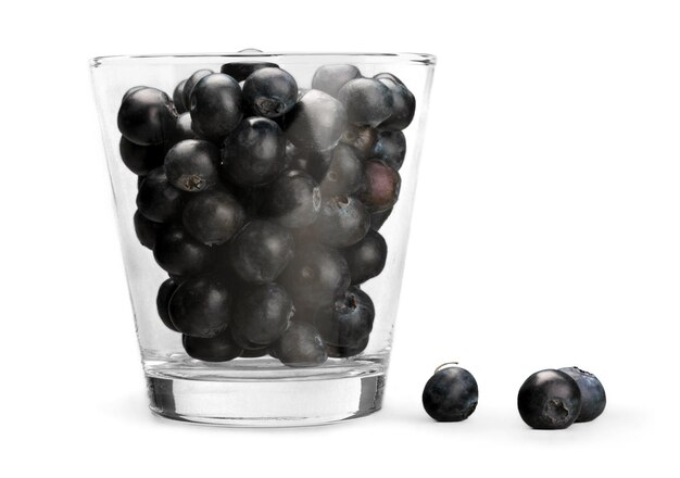 Fresh Ripe Blueberries in glass on white background