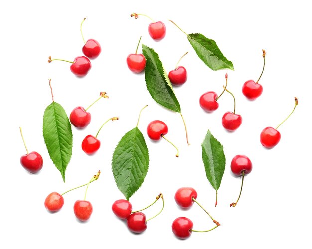 fresh ripe cherries and green leaves on white background