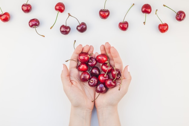 Fresh ripe cherry in a female hands