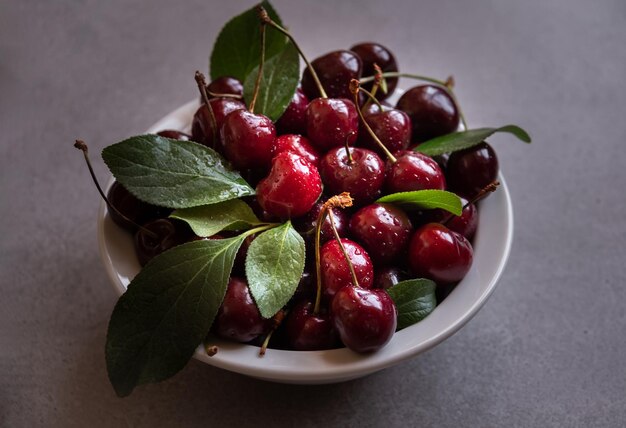 Fresh ripe cherry fruit with leaves in a bowl