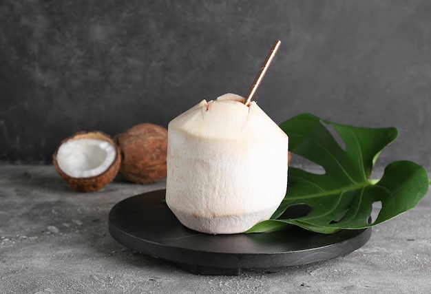 Fresh and ripe coconuts on grey surface