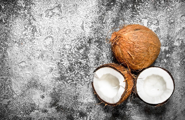 Fresh ripe coconuts. On a rustic background.