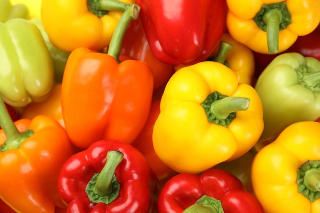 Fresh ripe colorful bell peppers as background top view