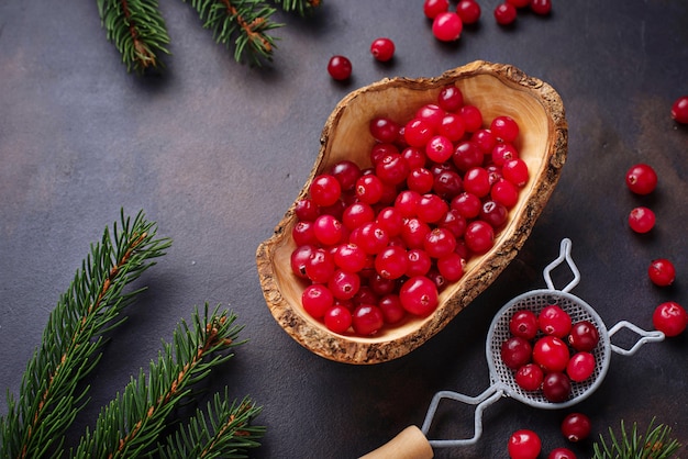 Fresh ripe cranberry in wooden bowl