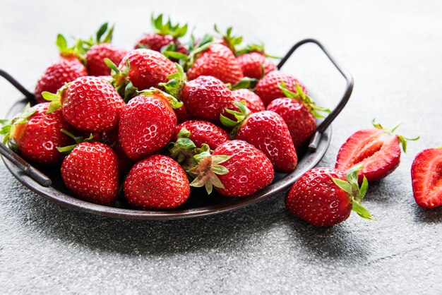 Fresh ripe delicious strawberries in a metal bowl