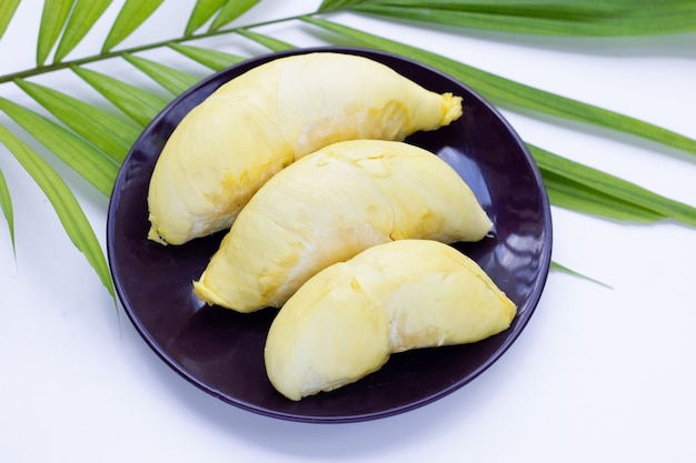Fresh ripe durian in plate on green leaf