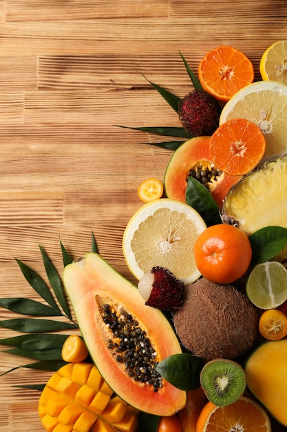 Fresh ripe exotic fruits on wooden background.