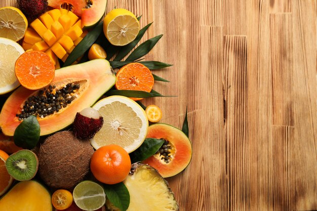 Fresh ripe exotic fruits on wooden background