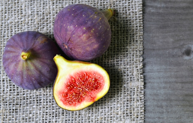 Fresh ripe fig fruits on a burlap cloth background