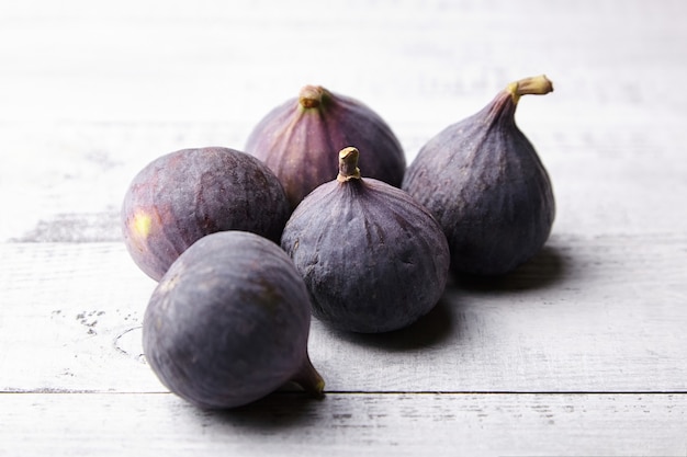 Fresh ripe fig fruits on grey wooden table