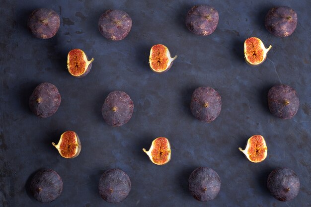 Fresh ripe figs on dark background, top view