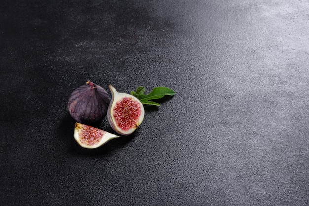 Fresh ripe figs on dark table