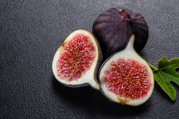 Fresh ripe figs on dark table