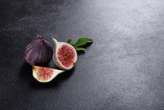 Fresh ripe figs on dark table