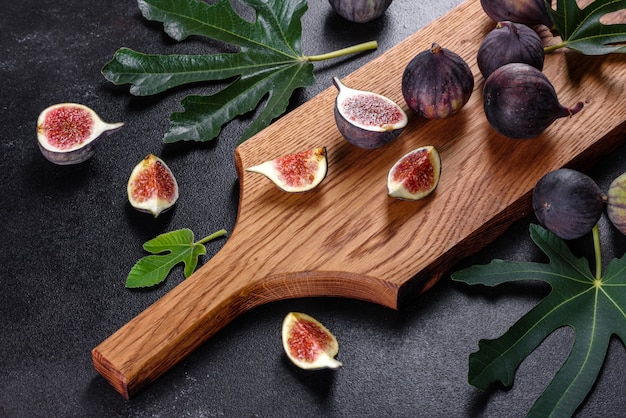 Fresh ripe figs on dark table