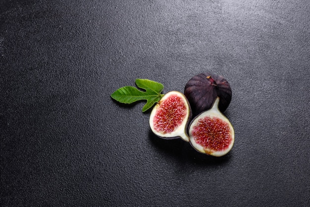 Fresh ripe figs on dark table