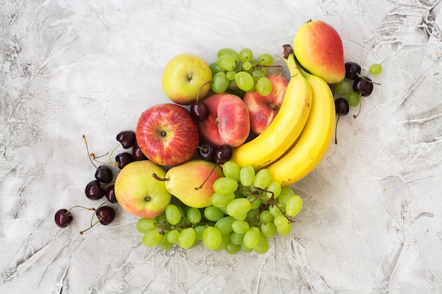 Fresh ripe fruits over stone table. Top view