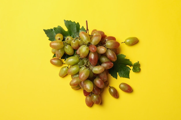 Fresh ripe grape on yellow, top view