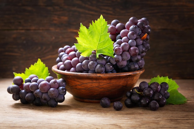 Fresh ripe grapes with leaves in a bowl