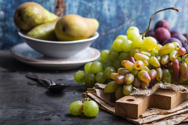 Fresh ripe grapes on wooden cutting board