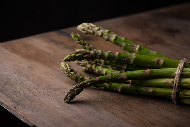 Asparagi verdi maturi freschi su sfondo scuro