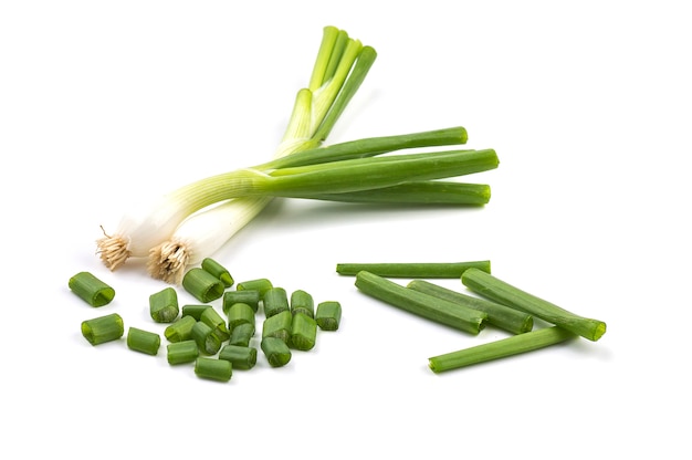 Fresh ripe green spring onions (shallots or scallions) with fresh chopped green onions on white background