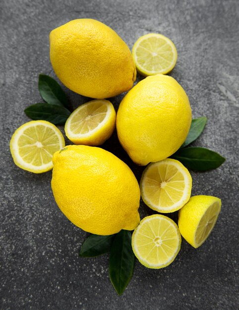 Fresh ripe lemons on dark background