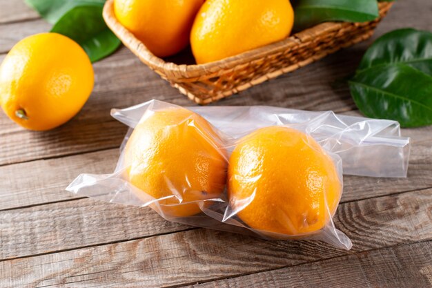 Fresh ripe lemons in a freezer bag on a wooden table