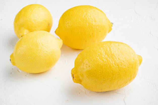 Fresh ripe lemons set, on white stone table background