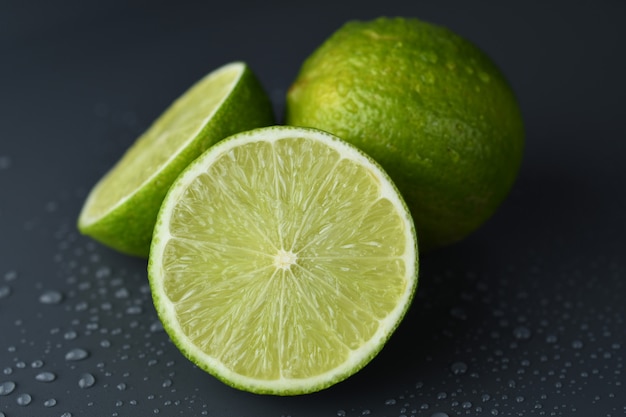 Fresh ripe limes  with water drop