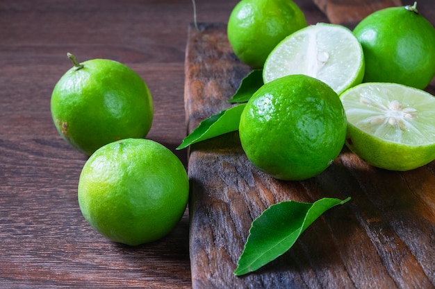 Fresh ripe limes on wooden background