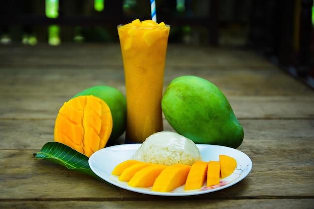 Fresh ripe mango and sticky rice with mango juice, authentic Thai dessert,Thai seasonal fruit.