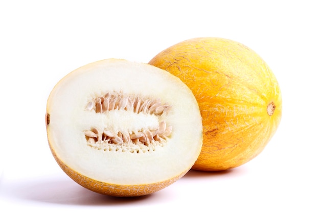 Fresh ripe melon isolated on white background. A piece of melon cut in half.