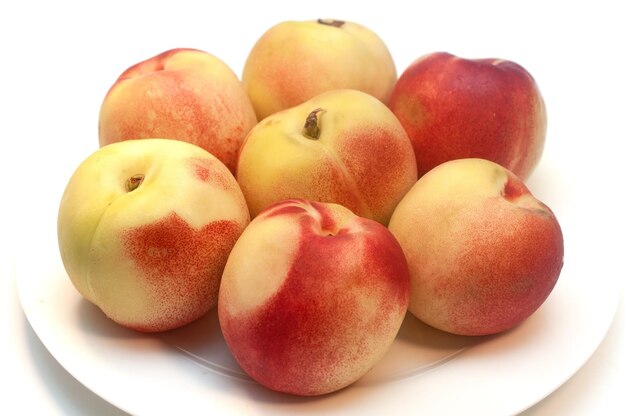 Fresh ripe nectarines isolated on white background