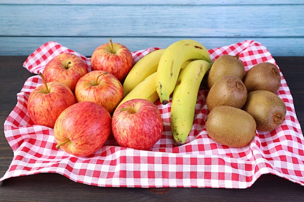 Fresh Ripe Nutritious Fruits on a Tray with Checkered Clothed on the Wooden Rustic Table