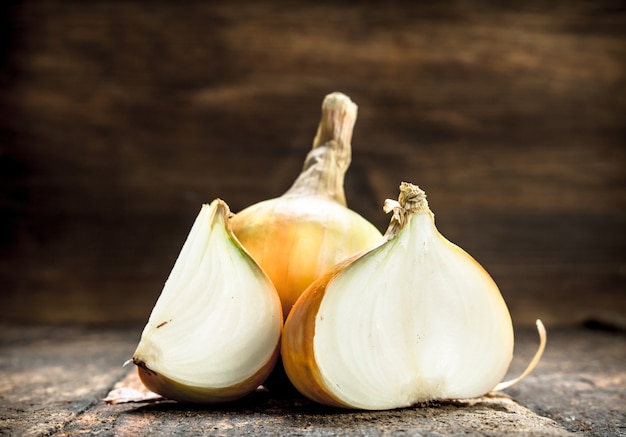 Fresh ripe onions. On a wooden background.