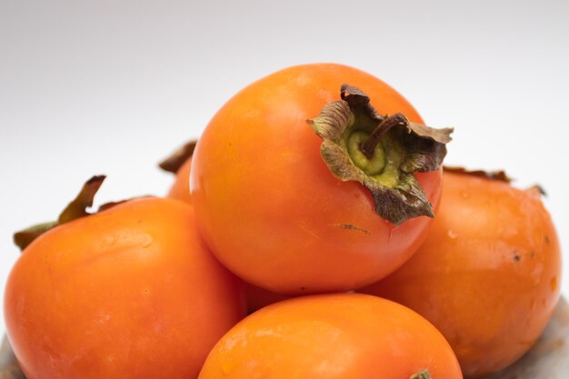 Fresh Ripe orange Persimmons on a plate