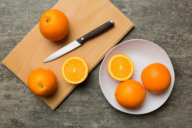 Fresh ripe oranges on cutting board on table Top view Flat lay