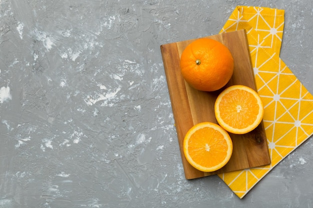 Fresh ripe oranges on cutting board on table Top view Flat lay