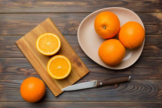 Fresh ripe oranges on cutting board on table Top view Flat lay