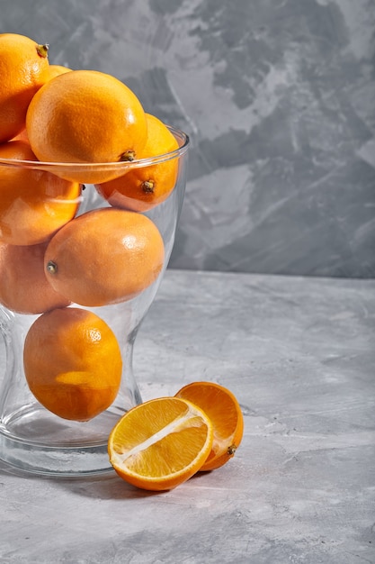 Fresh ripe oranges on dark stone background side view with copy space