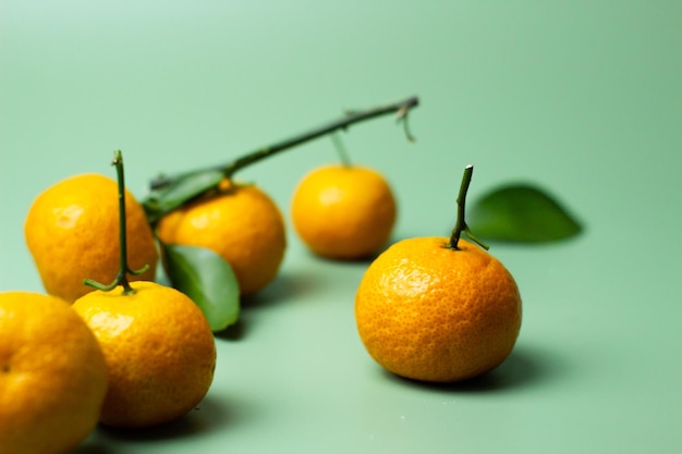 Fresh and ripe oranges on a green background concept photo