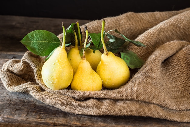 Fresh ripe organic pears on rustic wooden table, natural background, vegetarian, diet food