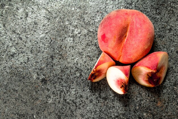 Fresh ripe peaches on a rustic background