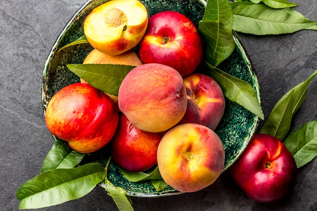 Fresh ripe peaches with peach tree leaves