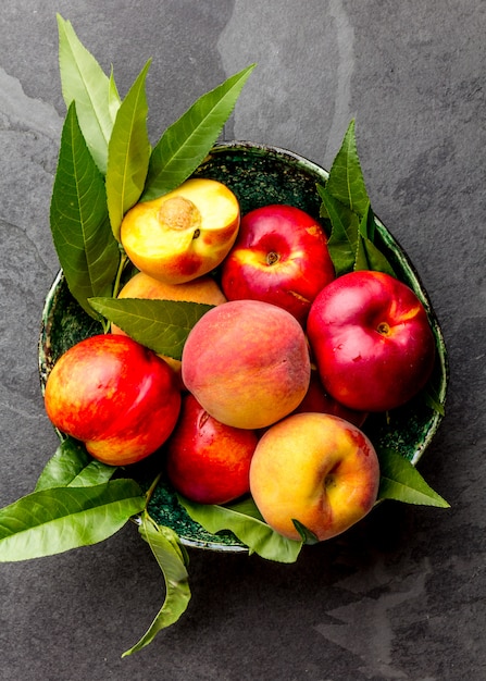 Fresh ripe peaches with peach tree leaves